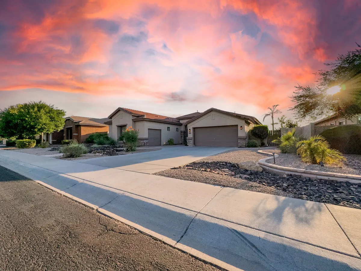This exterior image shows a welcoming view of well-kept houses with manicured landscaping and a spacious driveway, capturing the essence of a family-friendly neighborhood. The scene suggests community life, with the potential for family gatherings, evening strolls, and neighbors interacting outdoors.